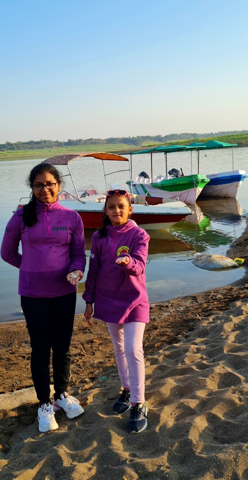 Eedha and Raesha had a nice time collecting seashells from riverside sands.